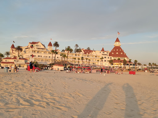 billiards at coronado beach. Coronado Beach as a vast expanse of soft, golden sand, stretched out beneath a vibrant blue sky. The air is filled with the refreshing scent of the ocean, and the gentle lapping of waves against the shore creates a soothing rhythm. The beach is bathed in warm sunlight, and the distant sounds of seagulls and beachgoers add to the lively atmosphere. While you can't see the stunning views of the Pacific Ocean, you can feel the cool breeze on your skin and hear the crashing waves as they roll onto the shore.